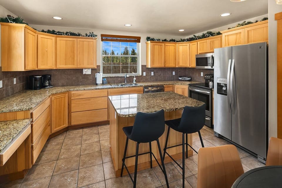 Evergreen Lodge. - Fully stocked kitchen with stainless appliances and granite countertops.