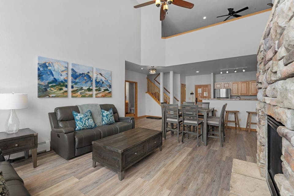 Living area with a gas fireplace, queen sleeper sofa, and balcony access.
