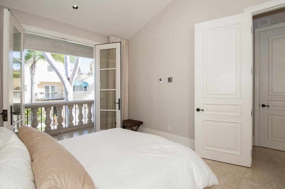 private bedroom suite on main level (2nd level) opens to a cozy balcony