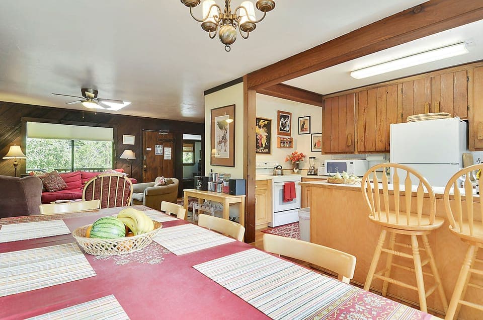 An open dining area with bar seating at the kitchen counter.
