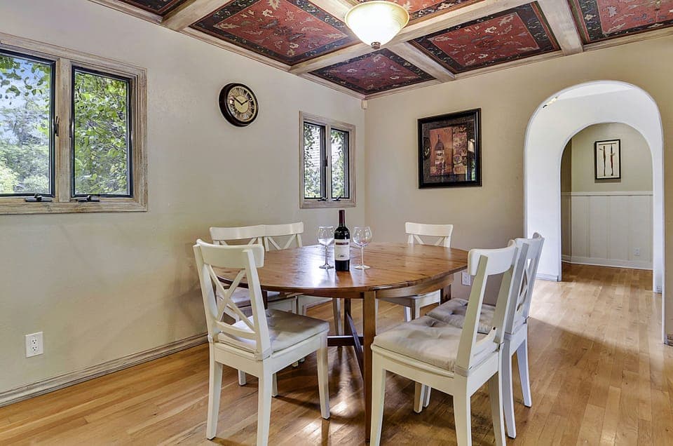 Dining nook opens to the kitchen and hallway to the downstairs bedrooms.