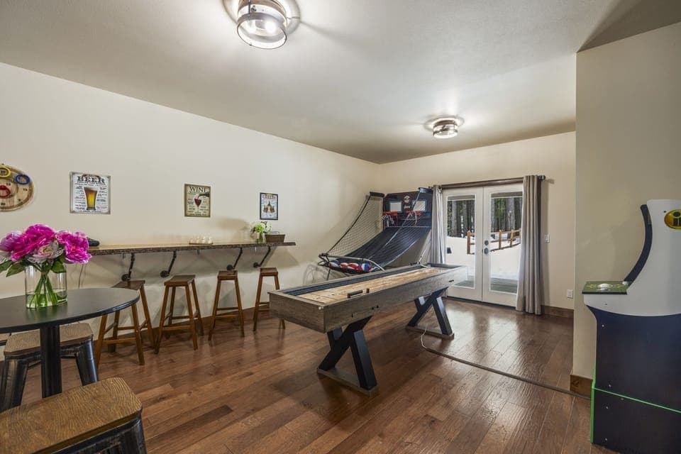 Game Room with a Shuffle Board, Pop-O-Shot, Pac Mac Acrade, 60" Flat Screen and Couch