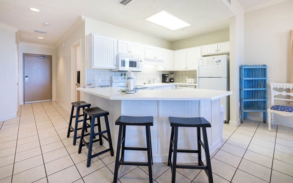 Gather around the inviting kitchen with bar stools, perfect for casual meals or coffee and conversations