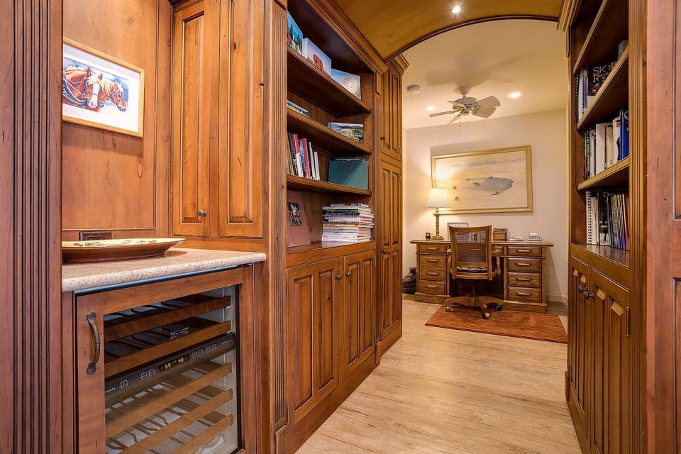 Your private study features rich wood built-ins, a wine cooler, and cozy reading nooks—perfect for quiet mornings with coffee.