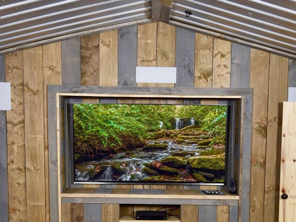 The theater room has a massive 85` 4K TV with surround sound speakers