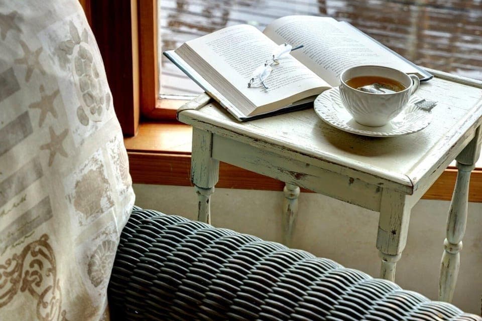 Relax with a cup of tea and a book from our library on a cozy, rainy day.
