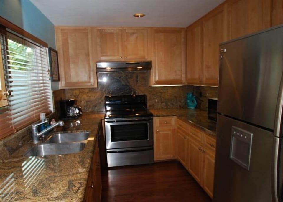 Updated kitchen with granite and stainless steel.