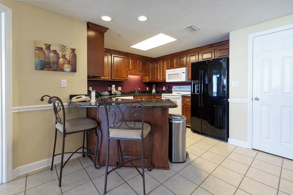 Gather around the stylish bar seating in this elegant kitchen, perfect for casual meals or morning coffee