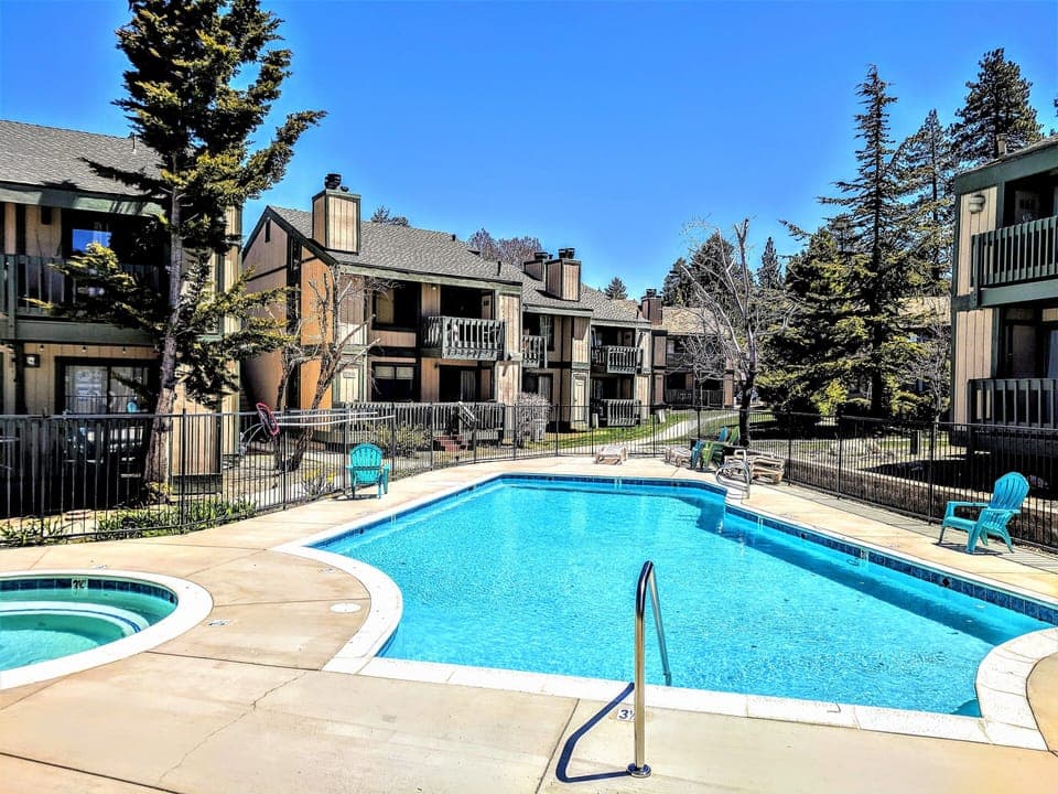 A wide view of the sparkling outdoor pool area nestled within the complex. Whether you're taking a morning dip or relaxing in the evening, this shared amenity is a highlight of the Boulder Creek resort lifestyle.