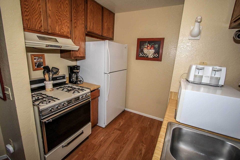 The kitchen comes with a full-sized refrigerator, gas stove, and oven. Ample cabinet space and essential appliances like a coffee maker ensure you have everything needed for home-cooked meals.