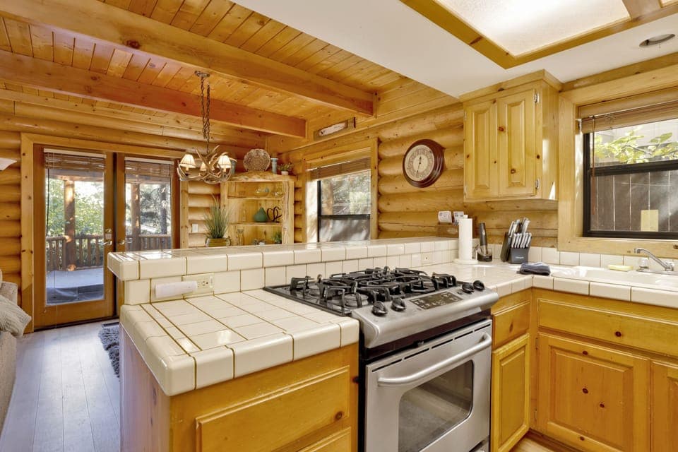 Fully equipped cabin kitchen with ample cabinetry, stove, fridge, microwave, and coffee maker—perfect for cooking meals, morning coffee, and feeling right at home on your stay.