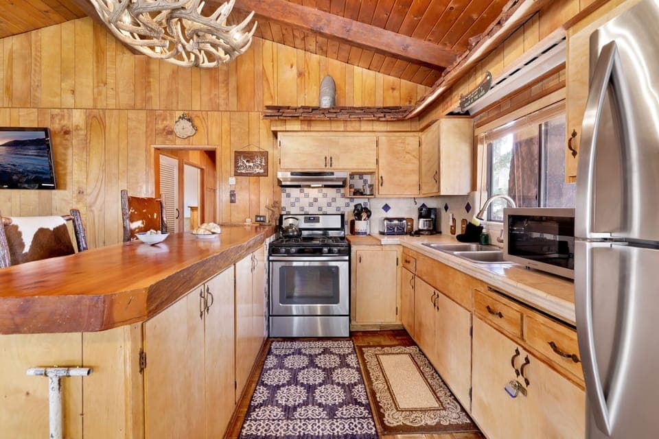 A well-lit kitchen with modern appliances, spacious countertops, and ample cabinetry. Ideal for preparing meals with ease and style.