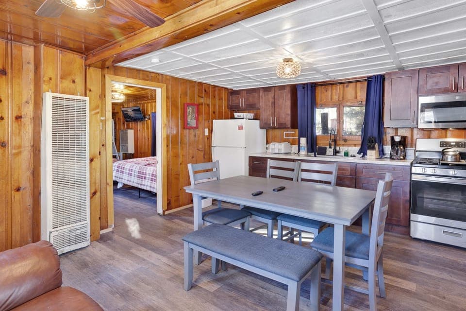 Kitchen with a refrigerator, stove, microwave, oven,coffee machine, and a dining table to enjoy a delicious meal.