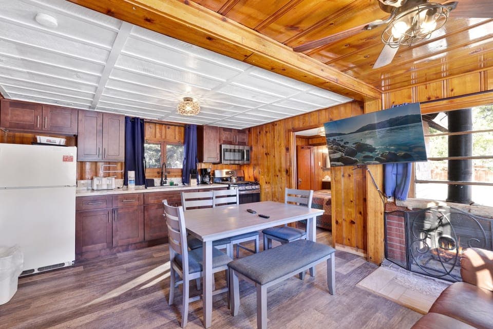 Kitchen with a refrigerator, stove, microwave, oven,coffee machine, and a dining table to enjoy a delicious meal.