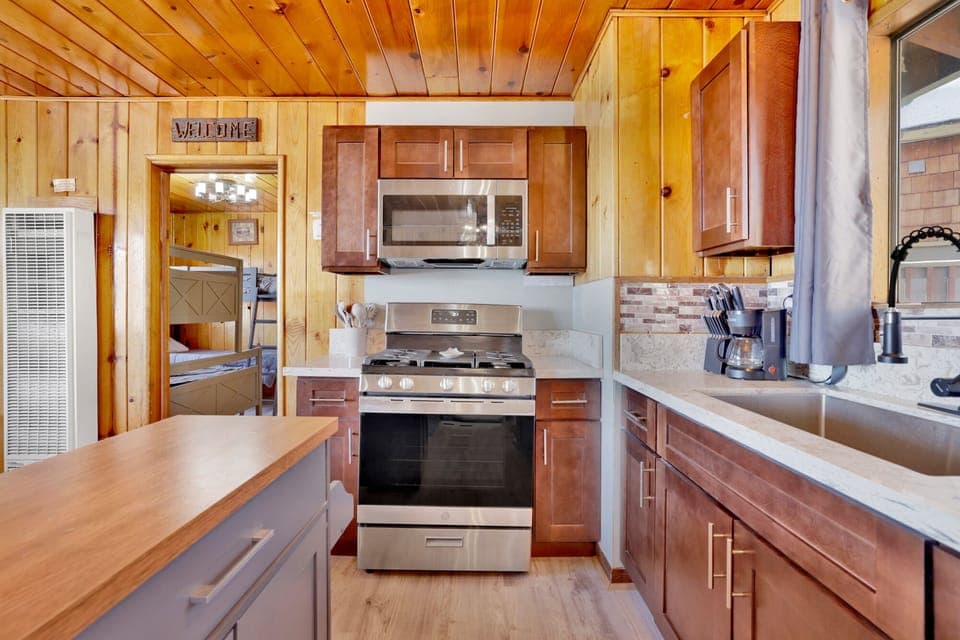 Kitchen with a refrigerator, stove, microwave, oven,coffee machine, and a dining table to enjoy a delicious meal.