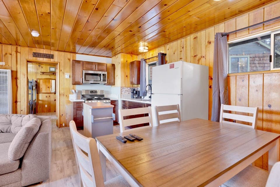 Kitchen with a refrigerator, stove, microwave, oven,coffee machine, and a dining table to enjoy a delicious meal.