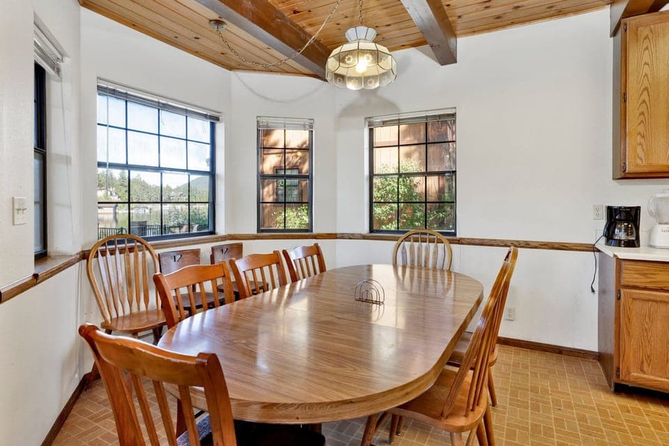 Fully equipped cabin kitchen with warm wood cabinets,stove, fridge, microwave, and coffee maker—perfect for cooking meals, morning coffee, and feeling right at home on your stay.