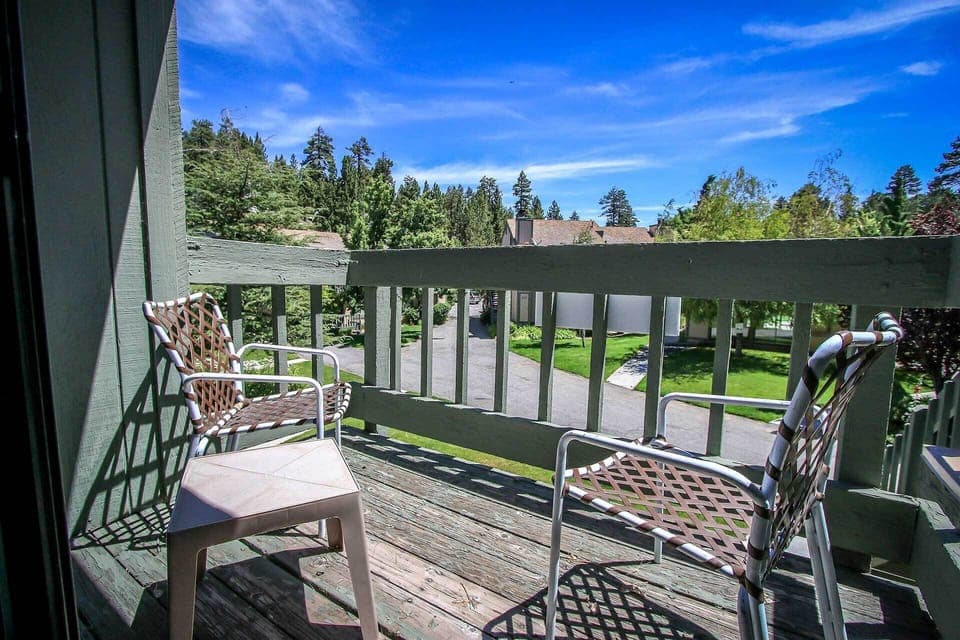 The master bedroom balcony features comfortable seating and scenic views. It's an ideal nook for a quiet morning coffee or unwinding in the afternoon sun while overlooking the local neighborhood.