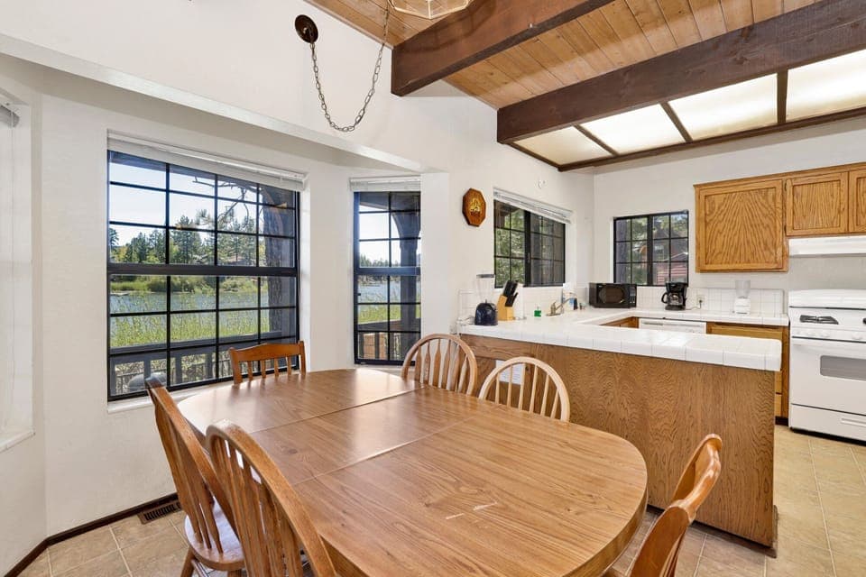 Fully equipped cabin kitchen with warm wood cabinets, stove, fridge, microwave, and coffee maker—perfect for cooking meals, morning coffee, and feeling right at home on your stay.