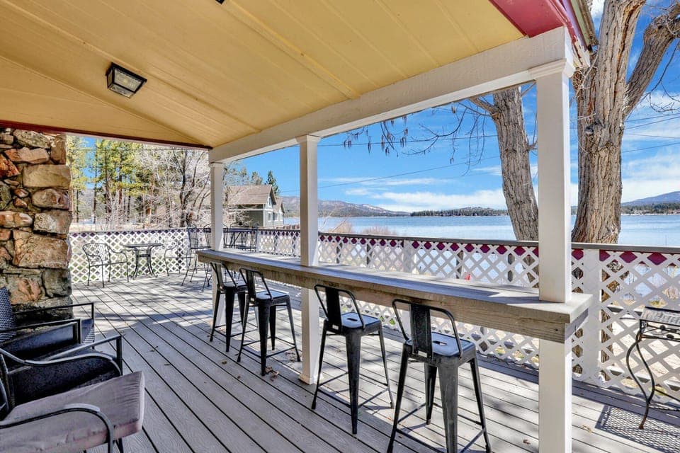 Private outdoor deck with comfortable seating and a BBQ, surrounded by tall pines, perfect for relaxing under the trees after a day of adventure—enjoy peaceful forest views, fresh air, and a truly rejuvenating stay.