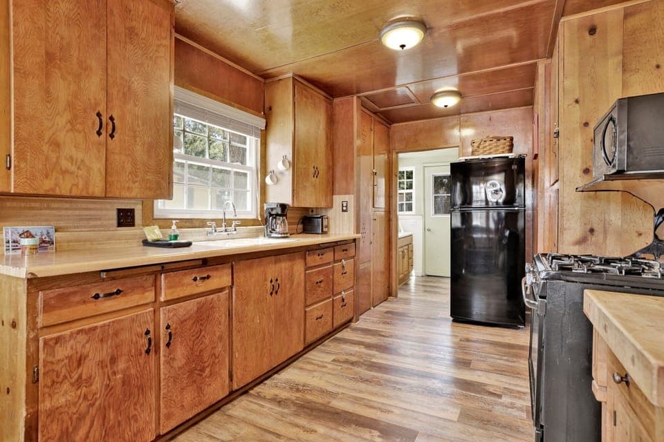 Fully equipped cabin kitchen with ample cabinetry, stove, fridge, microwave, and coffee maker—perfect for cooking meals, morning coffee, and feeling right at home on your stay.