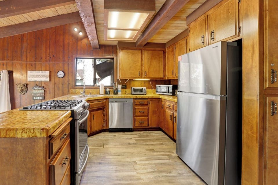 Fully equipped cabin kitchen with ample cabinetry, stove, fridge, microwave, and coffee maker—perfect for cooking meals, morning coffee, and feeling right at home on your stay.