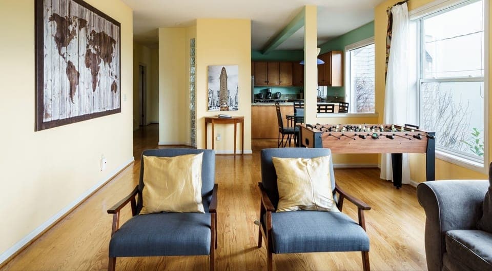 Living room has a foosball table, a TV,  many Games and books to enjoy.