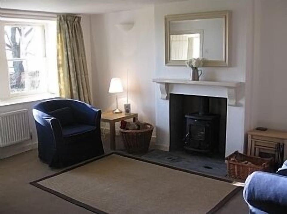 Sitting-room with woodburning stove and sea views