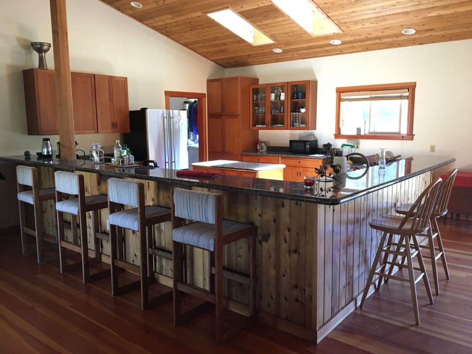 Spacious kitchen counters with stools, center island, skylights.  