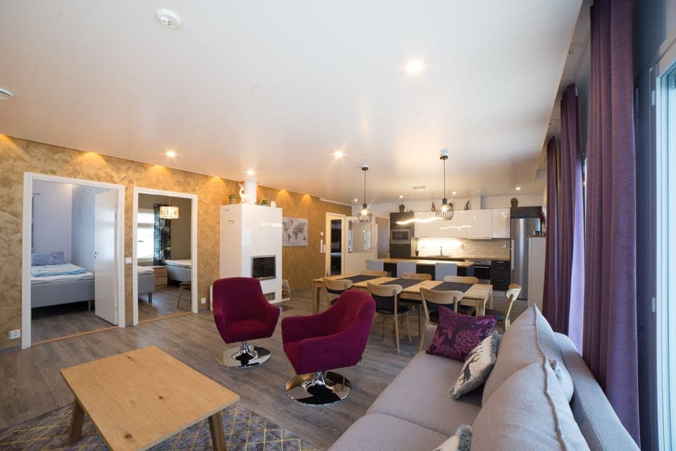 open concept living room kitchen dining area with fireplace and lake view
