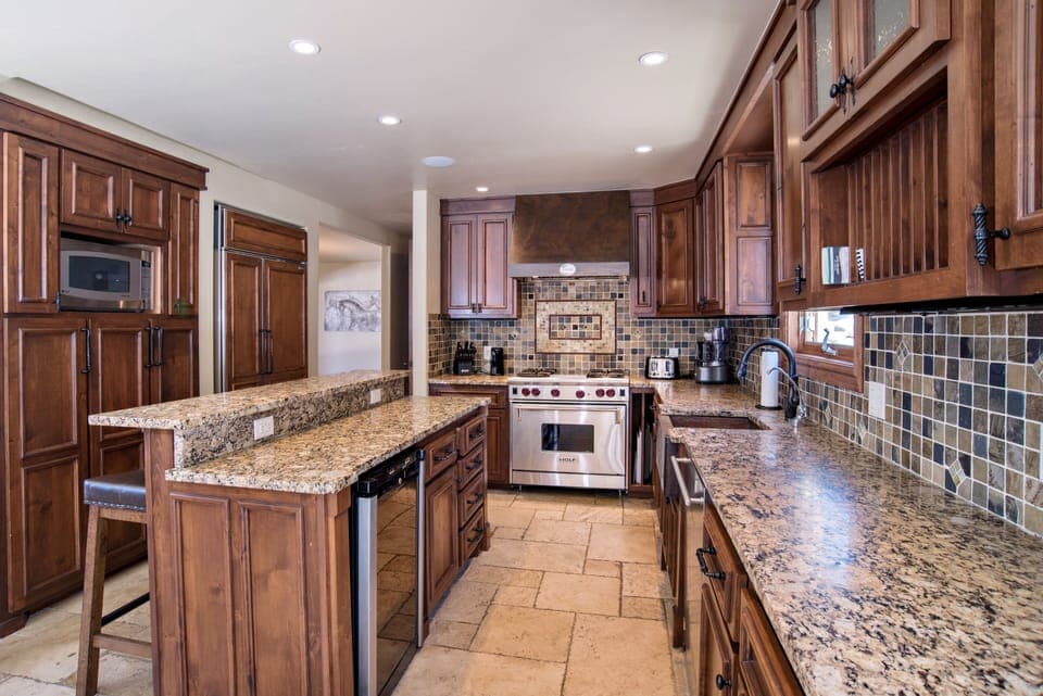 Kitchen with stainless steel appliances and stone countertops