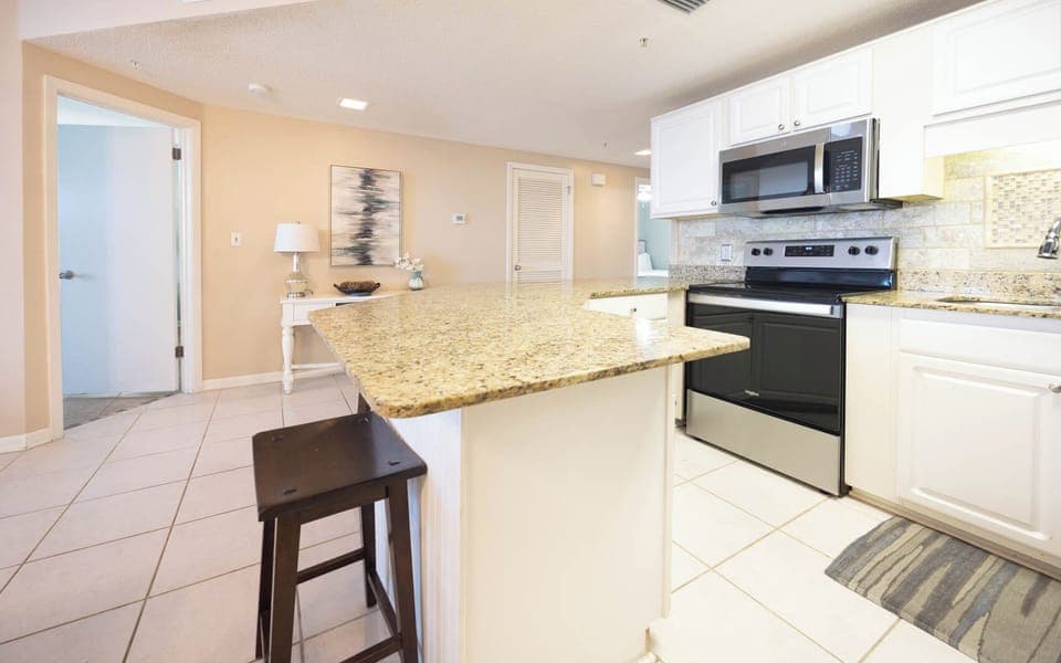 Prepare meals in the spacious kitchen with granite countertops and stainless appliances for a delightful culinary
