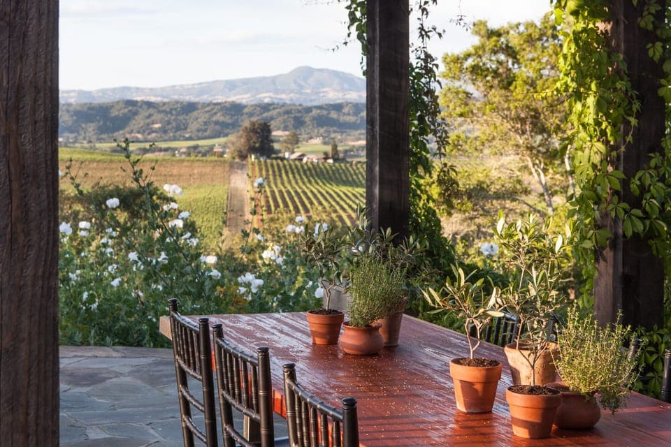Poolside pergola has panoramic view of Geyser Peak and vineyards.