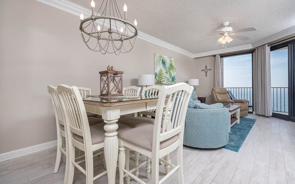 Gather around the dining table with comfortable seating, enjoying the coastal decor and inviting atmosphere