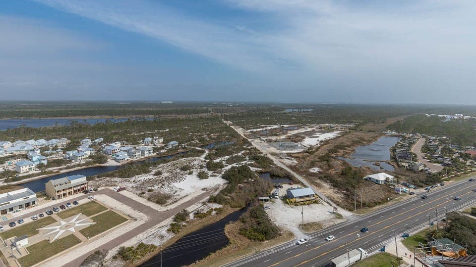 This view showcases serene landscapes with waterways and charming homes, perfect for a peaceful getaway