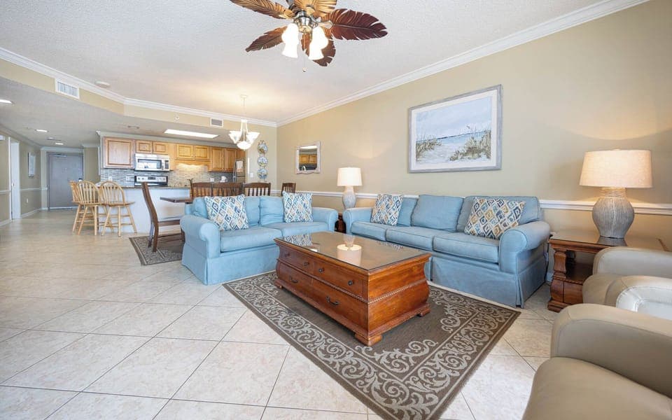 Unwind in the spacious living area, with a sofa with queen sleeper, coffee table, and a view of the dining space beyond