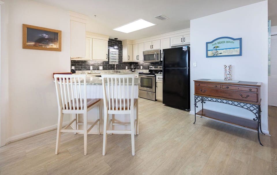 Enjoy meals or coffee at the stylish breakfast bar, surrounded by a elegant kitchen and inviting decor