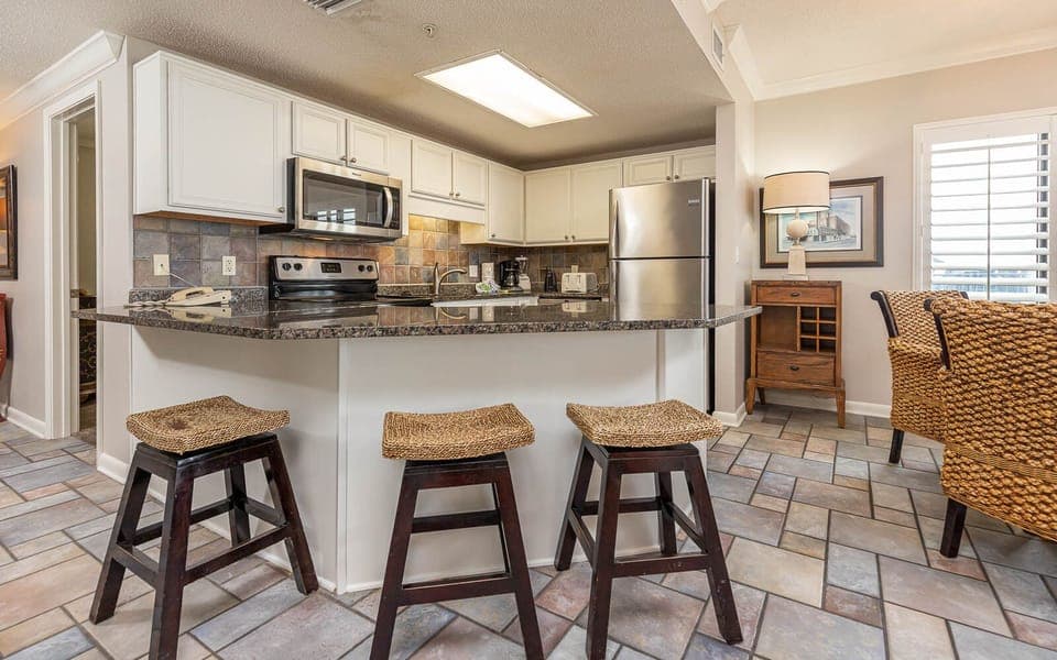 Enjoy cooking in the spacious kitchen with granite countertops, stainless appliances, and casual seating at the bar