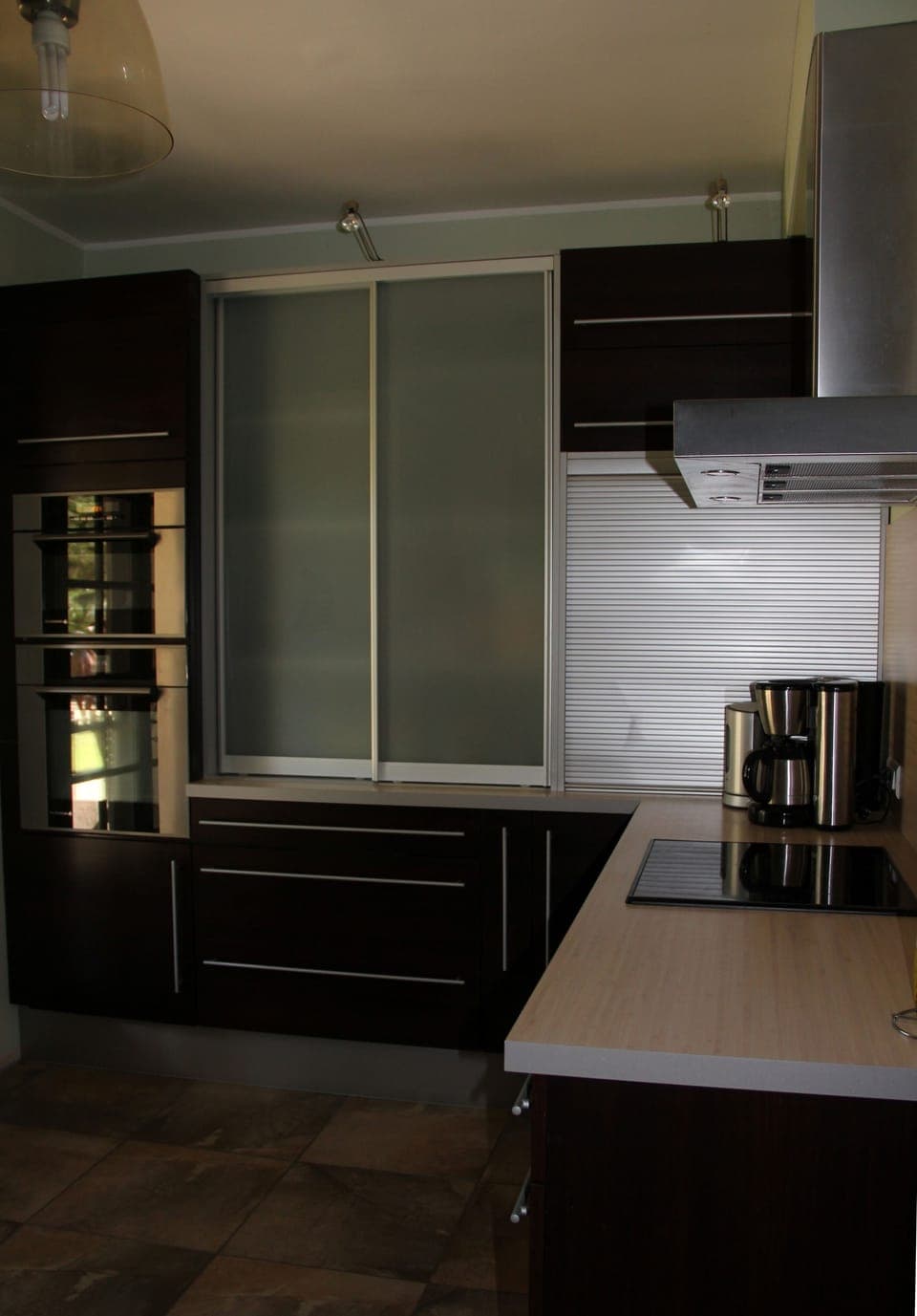 Kitchen: hob, coffee machine, oven, microwave and crockery store