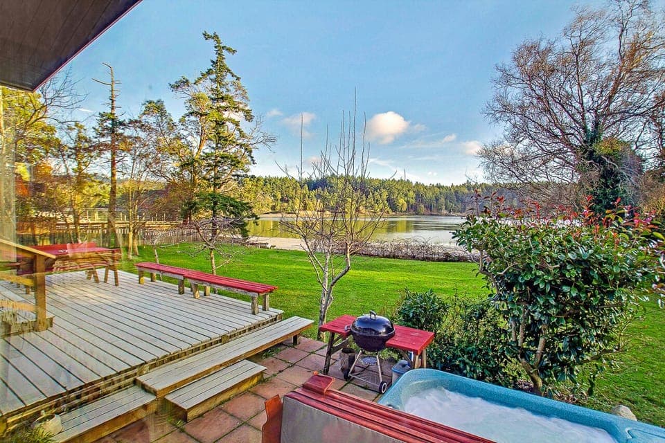 New Hot Tub! (February 2024) 
 The sunny deck leads right down to the yard, the shore, and the hot tub. It is also equipped with a charcoal grill for BBQing.