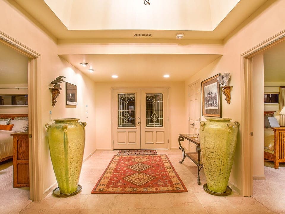 This is the main entrance hallway on the main floor (second floor). Master bedroom is upstairs and home theater is downstairs. Two guest bedrooms are seen on the left and the right.