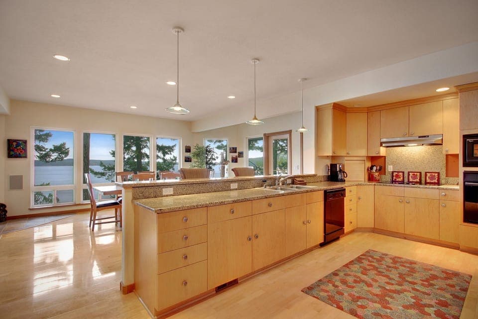 Fully equipped kitchen is open to the dining area.