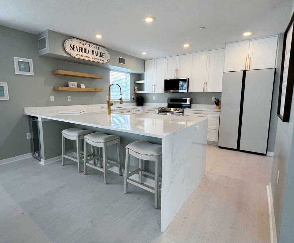 Completely updated kitchen, with all the necessities of home, in - Completely updated kitchen, with all the necessities of home, including bar stool seating, and a wine fridge.