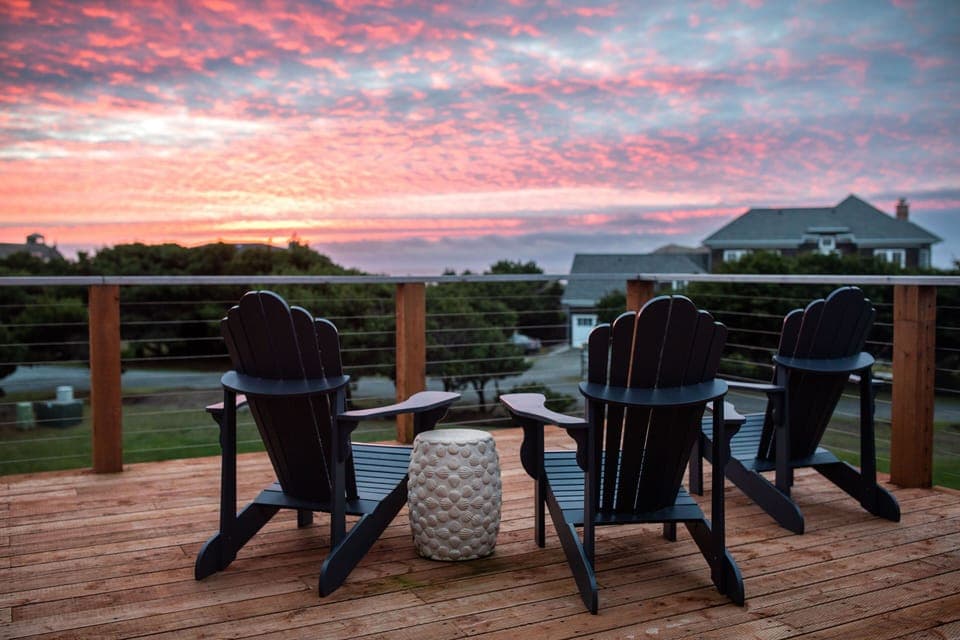 Sunset from large upper deck facing the white waters of the Pacific. 