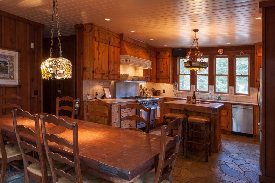 The dining room and kitchen, featuring a true commercial stove