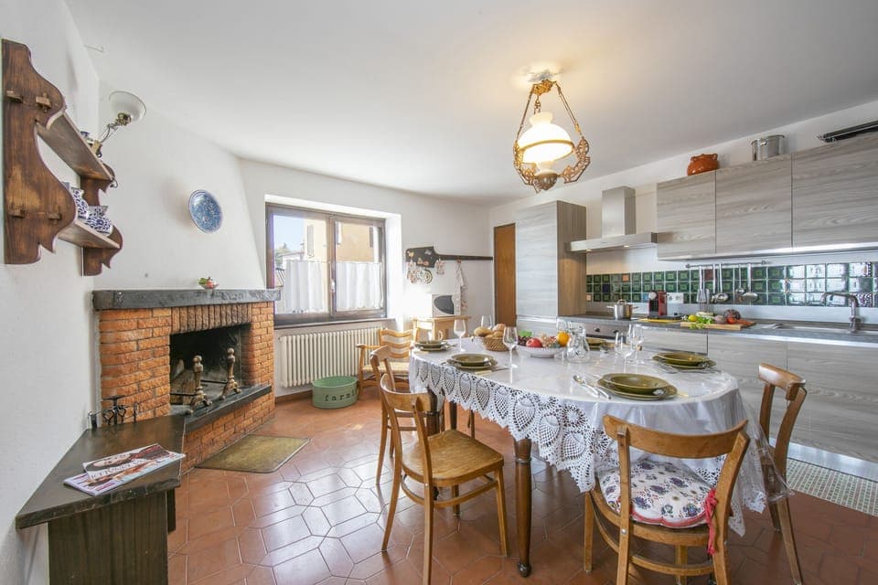 Kitchen with dining table and fireplace