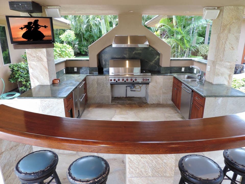 BBQ area with outdoor TV, Wolf grill, refrigerator  drawers, sink & bar