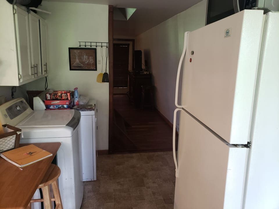 As you walk in to cabin washer dryer, stairs then living room