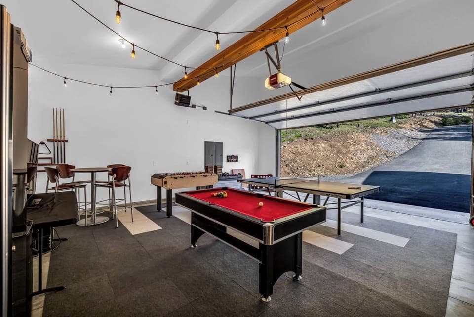 Game room with ping pong, foosball, pool table, TV, and lounge seating