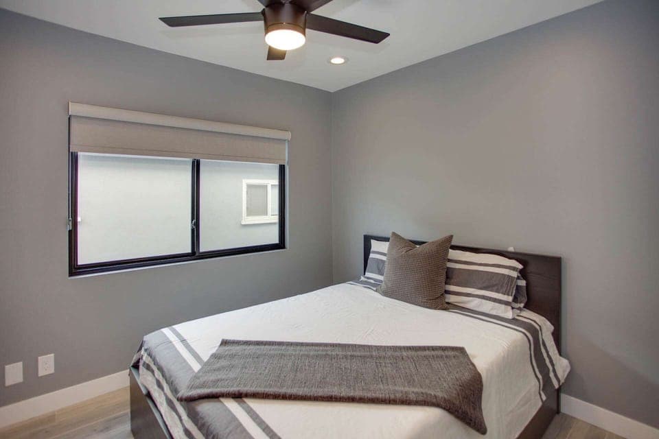 The second bedroom has alternate color patterns with a comfortable queen bed.